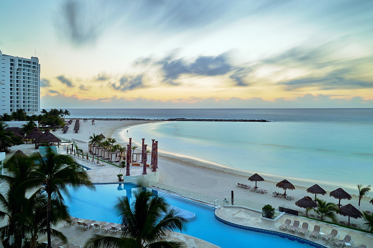 The view from hotel Krystal Cancun. Experimenting with very long exposures (3 min, 40 sec) . It was early morning, but there were already many people at the beach and pool. The long exposure made them